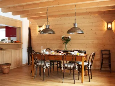 a dining room with a table and chairs at Les Chalets des Liarets in Chamonix-Mont-Blanc