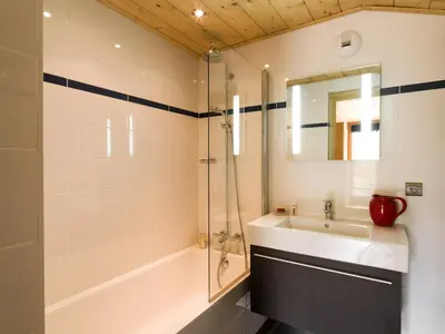 a bathroom with a sink and a shower at Les Chalets des Liarets in Chamonix-Mont-Blanc