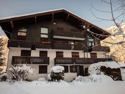a large building with snow in front of it at Superbe 3 pièces Chamonix - Jardin privé - Parking - Animaux admis - FR-1-517-25 in Chamonix-Mont-Blanc