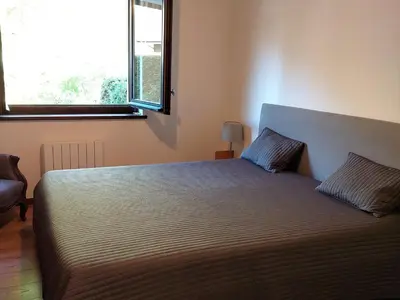 a bedroom with a large bed with a large window at Superbe 3 pièces Chamonix - Jardin privé - Parking - Animaux admis - FR-1-517-25 in Chamonix-Mont-Blanc