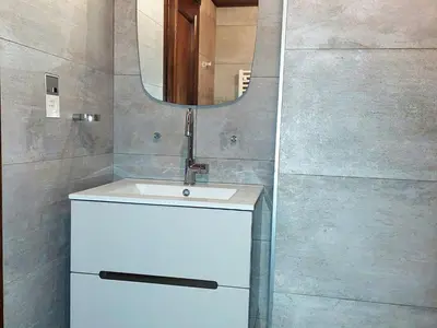 a bathroom with a sink and a mirror at Superbe 3 pièces Chamonix - Jardin privé - Parking - Animaux admis - FR-1-517-25 in Chamonix-Mont-Blanc