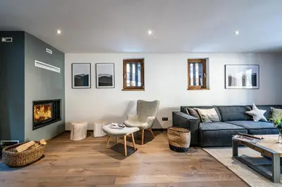 a living room with a couch and a fireplace at Le Globe Argentière Chamonix - by EMERALD STAY in Chamonix-Mont-Blanc