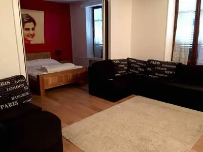 a living room with a couch and a mirror at Mont Blanc Residence in Saint-Gervais-les-Bains