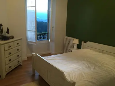 a bedroom with a white bed and a window at Mont Blanc Residence in Saint-Gervais-les-Bains
