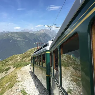 a train is going down a mountain with a view at Mont Blanc Residence in Saint-Gervais-les-Bains