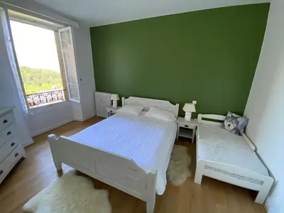 a bedroom with two beds and a green wall at Mont Blanc Residence in Saint-Gervais-les-Bains