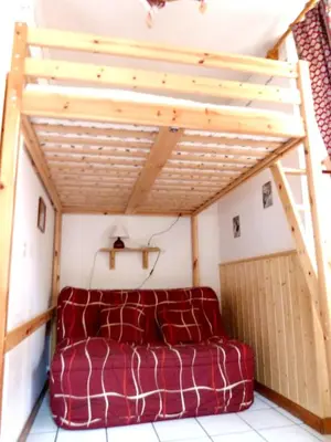a couch in a small room with a wooden ceiling at Studio chaleureux à Saint-Gervais-les-Bains, 23m², vue montagne in Saint-Gervais-les-Bains