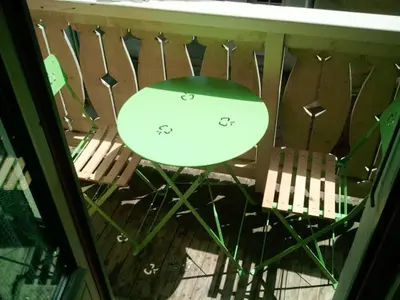 a table and two chairs on a balcony at Studio chaleureux à Saint-Gervais-les-Bains, 23m², vue montagne in Saint-Gervais-les-Bains