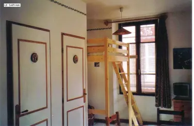 a room with a ladder and a room with a window at Studio chaleureux à Saint-Gervais-les-Bains, 23m², vue montagne in Saint-Gervais-les-Bains