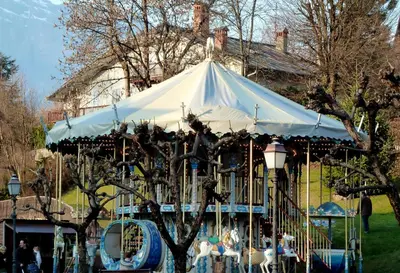 a white tent with people sitting on a carousel at Studio chaleureux à Saint-Gervais-les-Bains, 23m², vue montagne in Saint-Gervais-les-Bains