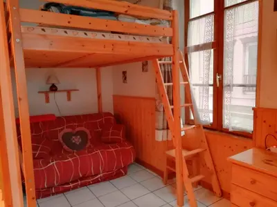 a room with a bunk bed and a couch at Studio chaleureux à Saint-Gervais-les-Bains, 23m², vue montagne in Saint-Gervais-les-Bains