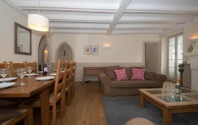 a living room with a table and a couch at Lutetia Apartment - Chamonix All Year in Chamonix-Mont-Blanc