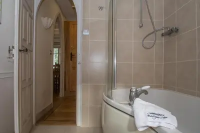 a bathroom with a bath tub and a sink at Lutetia Apartment - Chamonix All Year in Chamonix-Mont-Blanc
