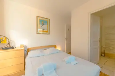 a bedroom with a bed with two towels on it at Appartement Etchea- 202 - Happy Rentals in Saint-Gervais-les-Bains