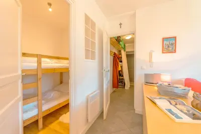 a small room with bunk beds and a desk at Appartement Etchea- 202 - Happy Rentals in Saint-Gervais-les-Bains