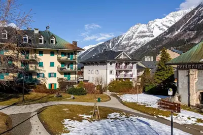 a resort with snow capped mountains in the background at Le Panoramic Mont Blanc Apartment - Chamonix All Year in Chamonix-Mont-Blanc