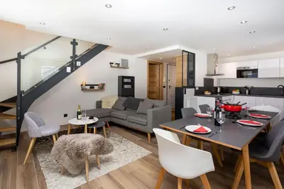 a kitchen and living room with a table and chairs at Le Panoramic Mont Blanc Apartment - Chamonix All Year in Chamonix-Mont-Blanc
