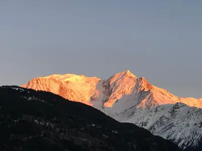 a group of mountains with the sun shining on them at Le petit Chamois in Saint-Gervais-les-Bains