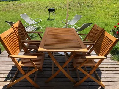 a wooden table and four chairs on a deck at Le petit Chamois in Saint-Gervais-les-Bains