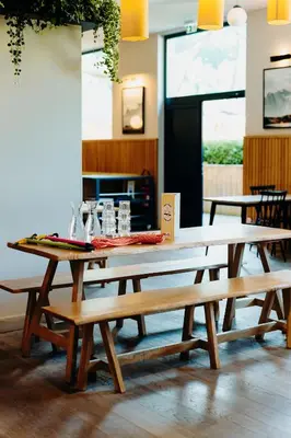 a group of picnic tables in a room at PlanB Hotel - Living Chamonix in Chamonix-Mont-Blanc