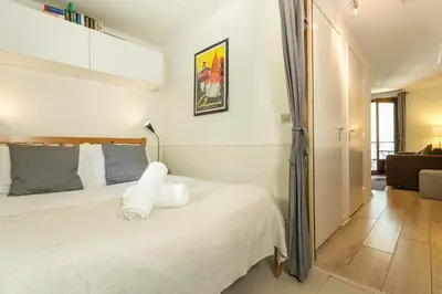 a bedroom with a bed and a living room at Apartment Blanc Neige 2 - Centre de Chamonix in Chamonix-Mont-Blanc