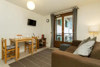a living room with a couch and a table at Apartment Blanc Neige 2 - Centre de Chamonix in Chamonix-Mont-Blanc