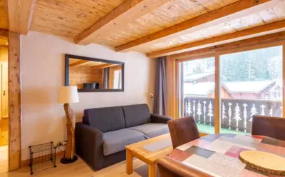 a living room with a couch and a table at Home sweet home in Chamonix-Mont-Blanc