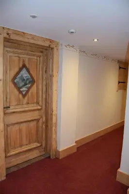 an empty room with a wooden door at Home sweet home in Chamonix-Mont-Blanc