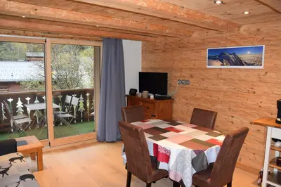 a dining room with a table and a balcony at Home sweet home in Chamonix-Mont-Blanc
