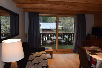 a living room with a view of a balcony at Home sweet home in Chamonix-Mont-Blanc