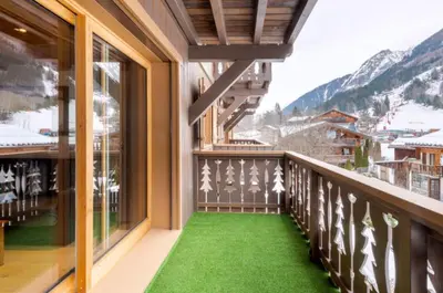 a balcony with green grass and a view of a mountain at Home sweet home in Chamonix-Mont-Blanc