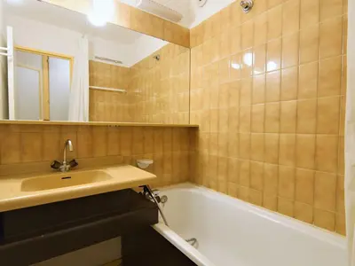 a bathroom with a sink and a bath tub at Apartment Jonquilles-10 by Interhome in Chamonix-Mont-Blanc