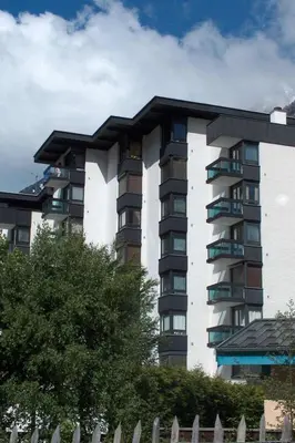 a tall apartment building with a fence in front of it at Studio L'Aiguille du Midi-8 by Interhome in Chamonix-Mont-Blanc