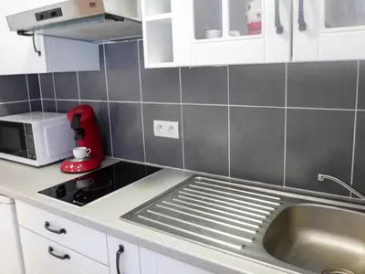 a kitchen with a sink and a red appliance at Studio L'Aiguille du Midi-8 by Interhome in Chamonix-Mont-Blanc