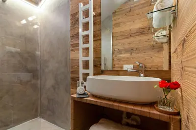 a bathroom with a white sink and a shower at Mazot du Mont-Blanc - Happy Rentals in Chamonix-Mont-Blanc