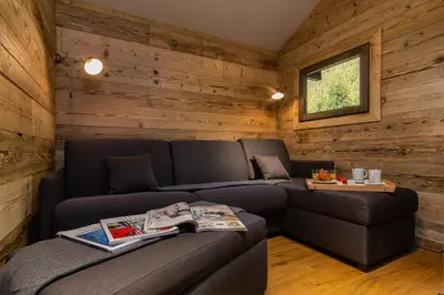 a living room with a couch and a table at Mazot du Mont-Blanc - Happy Rentals in Chamonix-Mont-Blanc