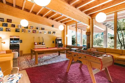 a living room with a pool table and ping pong ball at Big Sky Hotel & Spa in Chamonix-Mont-Blanc