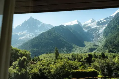 a view of a mountain range from a window at Big Sky Hotel & Spa in Chamonix-Mont-Blanc