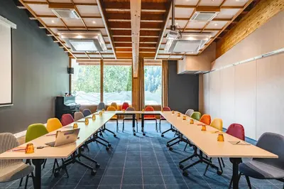 a conference room with long tables and chairs at Big Sky Hotel & Spa in Chamonix-Mont-Blanc