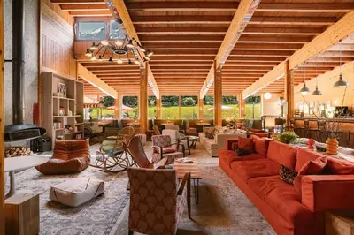 a large living room with couches and chairs at Big Sky Hotel & Spa in Chamonix-Mont-Blanc