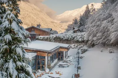 a ski lodge in the mountains with snow on the ground at Big Sky Hotel & Spa in Chamonix-Mont-Blanc