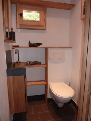 a small bathroom with a toilet and a sink at Chalet Les Lupins in Chamonix-Mont-Blanc