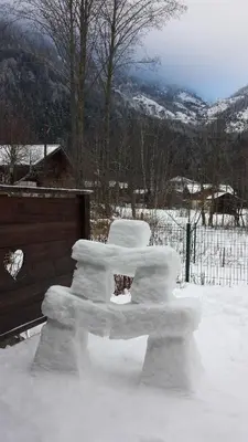 a bench covered in snow next to a fence at Chalet Les Lupins in Chamonix-Mont-Blanc