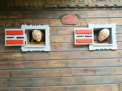 two faces in windows in a log cabin wall at Chalet Les Lupins in Chamonix-Mont-Blanc