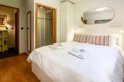 a bedroom with a white bed with towels on it at Le Paradis 15 Apartment - Chamonix All Year in Chamonix-Mont-Blanc