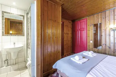 a bathroom with a bed and a sink and a sink at Hotel Le Chamonix in Chamonix-Mont-Blanc
