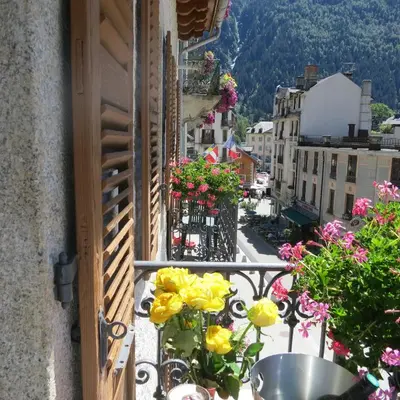 a balcony of a building with flowers on it at Hotel Le Chamonix in Chamonix-Mont-Blanc