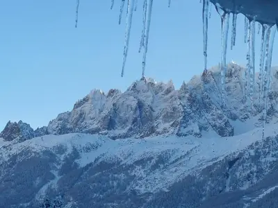 a snow covered mountain with icicles hanging from it at Les Chalets du Bonheur in Les Houches