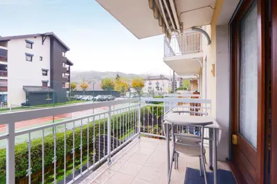 a balcony with a table and chairs and a view at Appartement Very - Welkeys in Sallanches