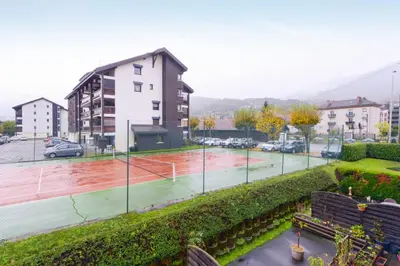 a tennis court in the middle of a parking lot at Appartement Very - Welkeys in Sallanches